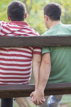 Two men holding hands